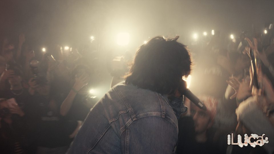 2Slimey close to the crowd in warm, smoky light