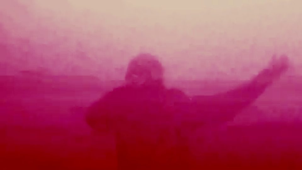 Arms outstretched in pink haze, EsDeeKid live