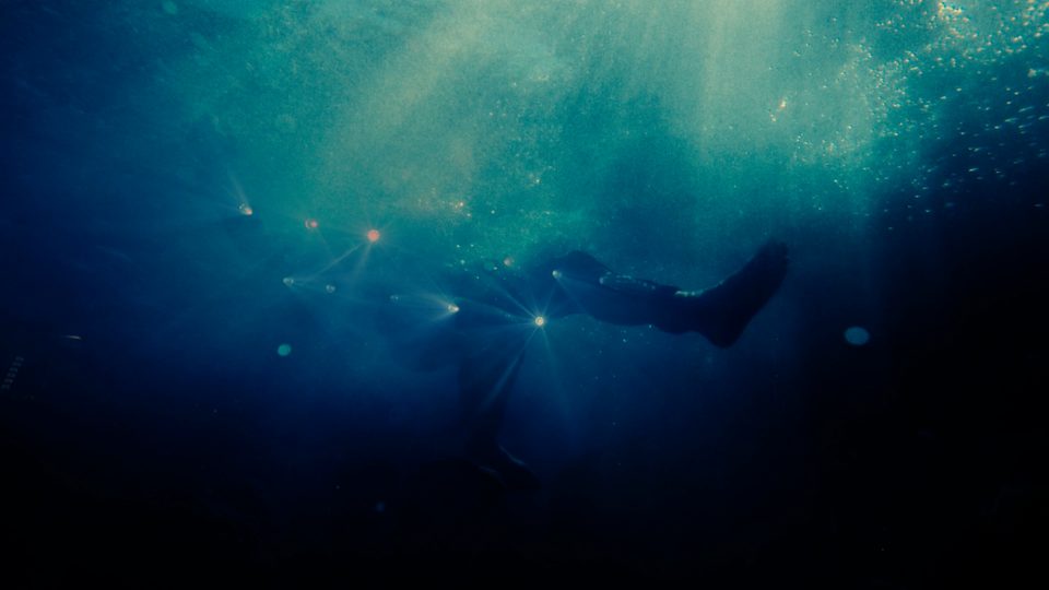 Figure underwater in dark blue light, Nettspend “F*CK SWAG” visual
